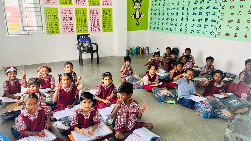 Schoolchildren with school kits donated through an Acceler8 GLOBAL community outreach visit